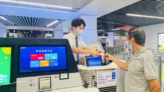 (辽阳东路站员工给乘客发售车票)