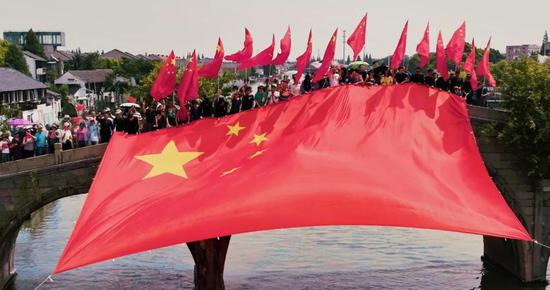 国旗在小桥流水的古镇飘扬这场特别快闪踏歌而来