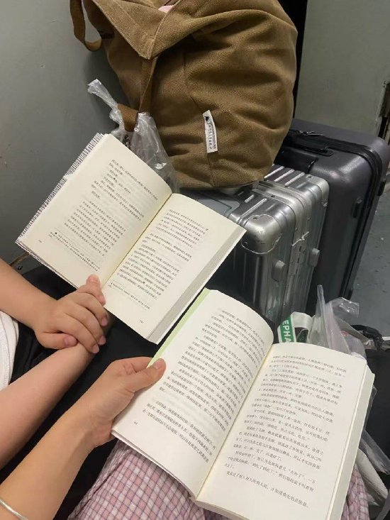 莫婷婷和同事在从桂林到武汉的通宵列车上，“幸好有书相伴”。（受访者提供）