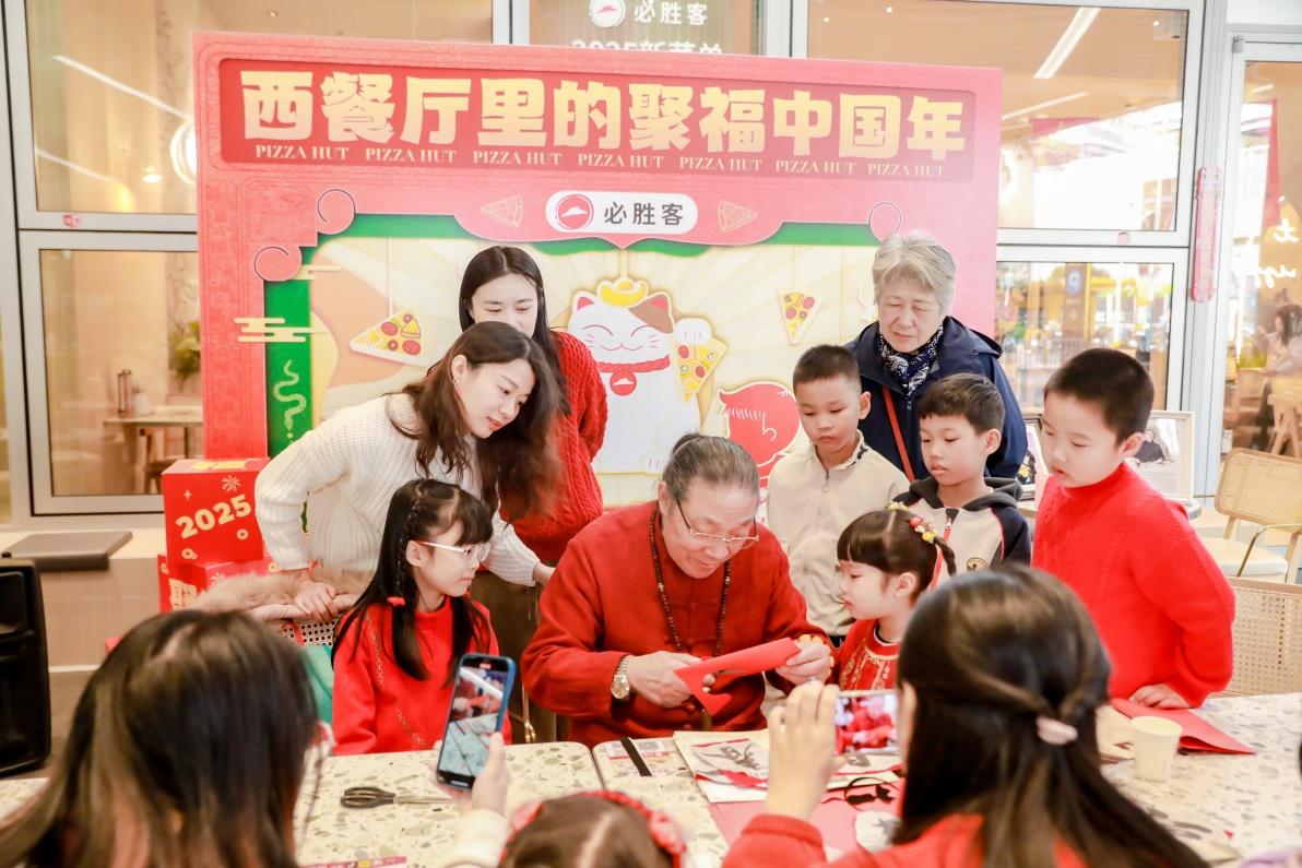 亲子家庭在必胜客餐厅跟非遗大师学习剪纸