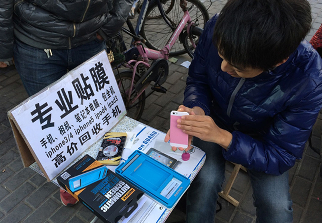 最后在街头,他用一张写着祖传贴膜的小板桌捍卫着曾经"华强北大鳄"的