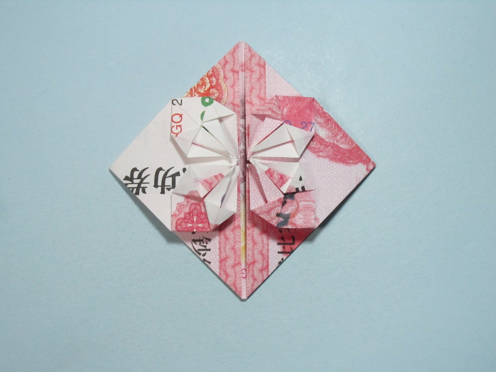 用人民币折纸爱心详细图解放在钱包里的爱心