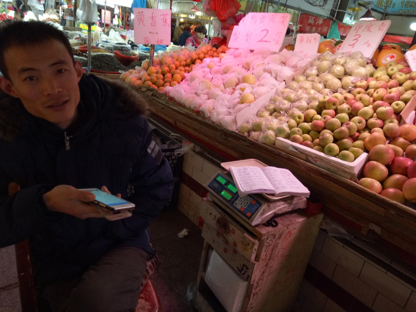 凡是在他摊位买水果的年轻人,他都会先询问一下,英语怎么样?