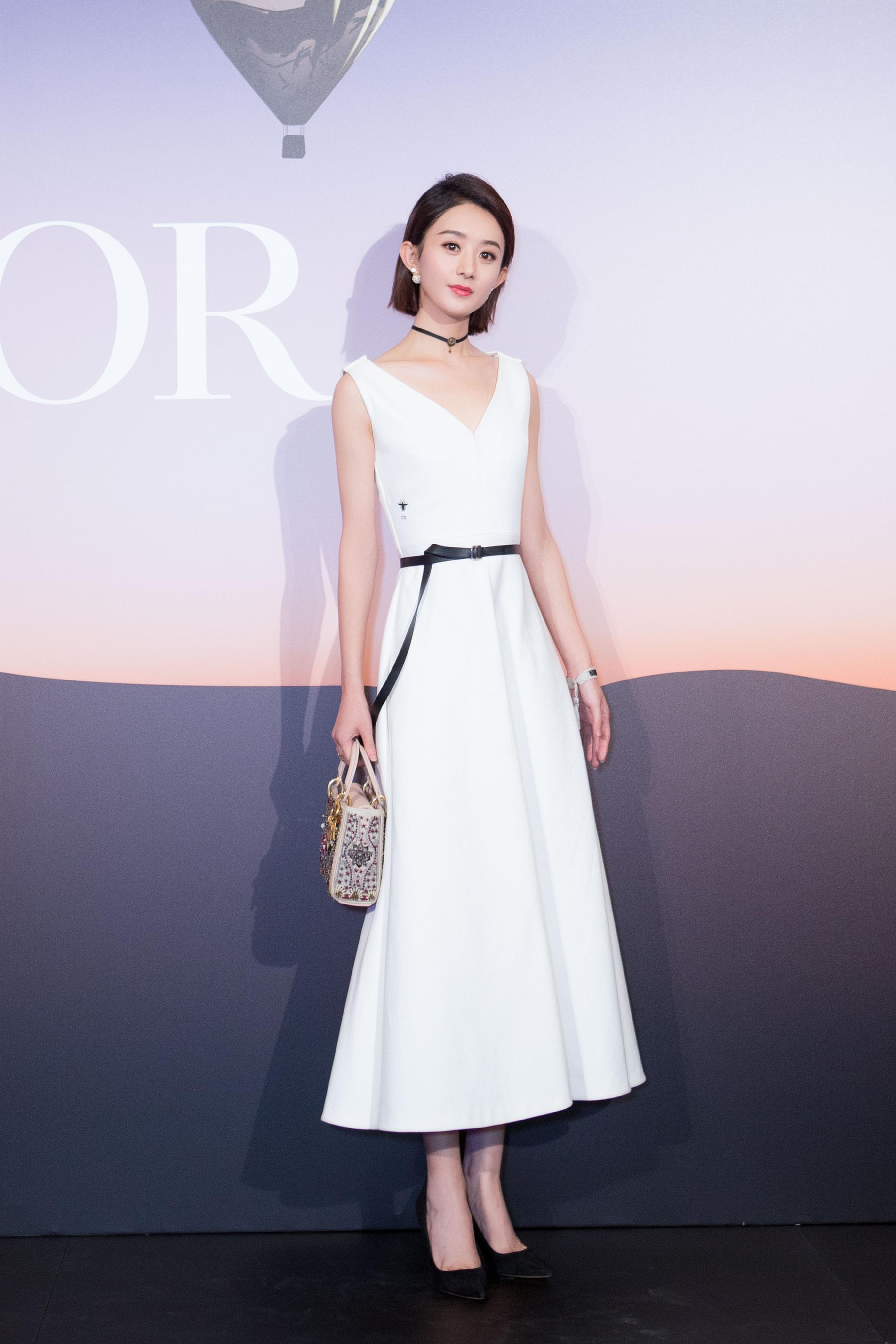 赵丽颖身穿白色连衣裙,脚踩一双黑色尖头高跟鞋,搭配短款发型修饰脸型