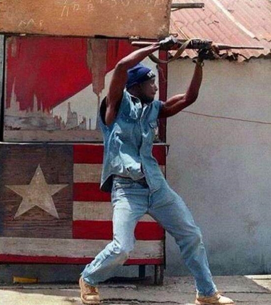 非洲士兵横拿ak头顶射击:姿势很销魂 到底什么名堂?