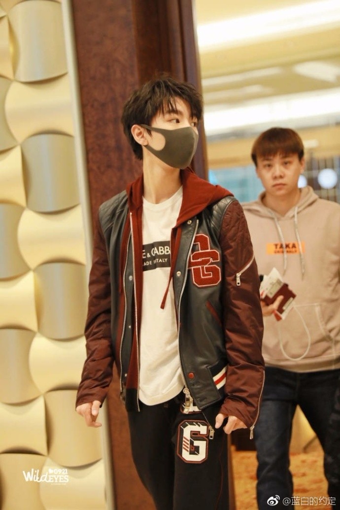 年轻帅气的凯凯带着黑色口罩,上身穿连帽夹克,一条休闲裤凸显出他完美