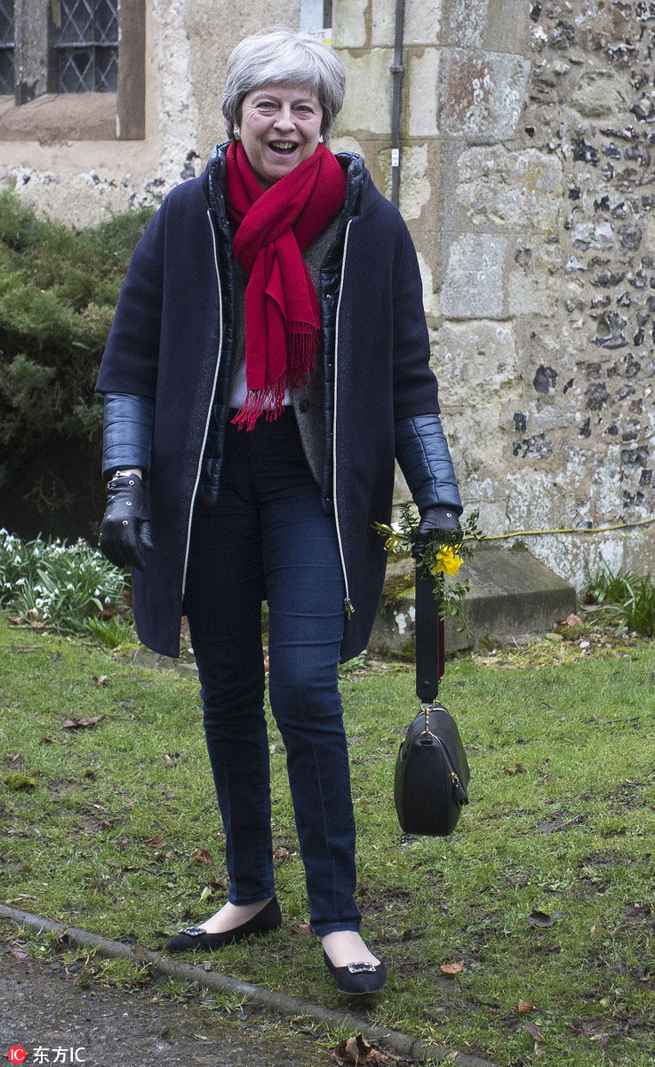 特蕾莎-梅与丈夫现身教堂做礼拜 弯腰逗狗心情大好