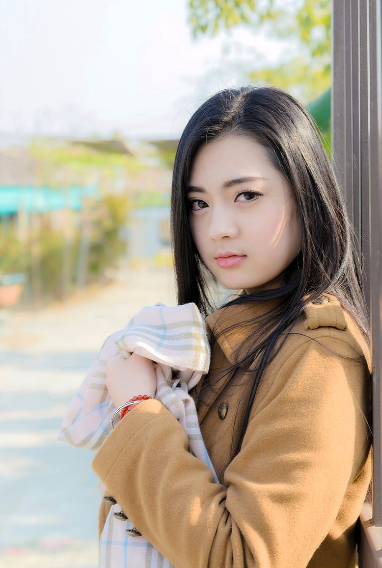 冬日阳光下一个长发飘飘的青春美丽女孩