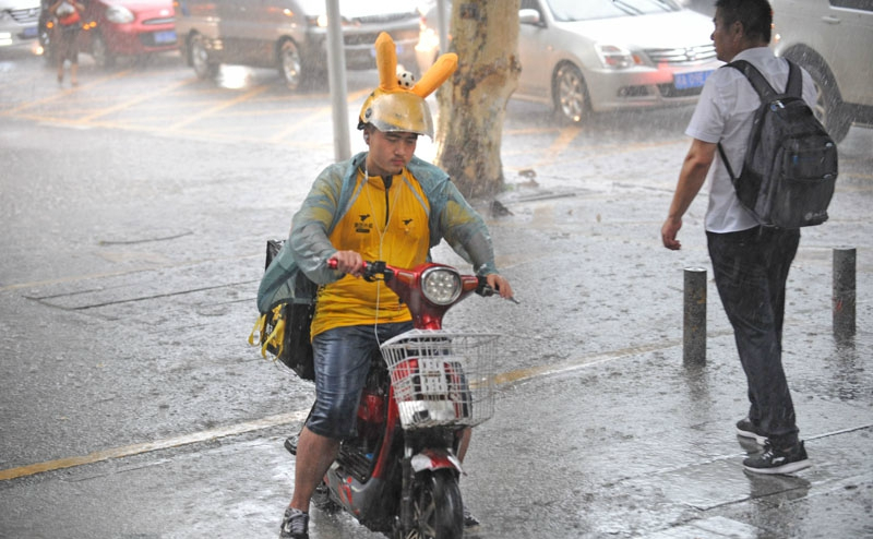 暴雨袭江城外卖小哥雨中疾驰送餐忙