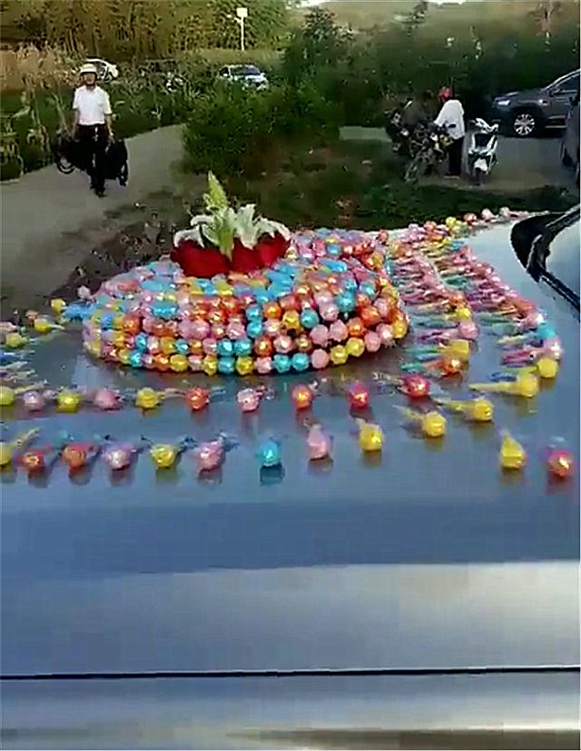 贵州一辆宝马7系婚车,车身被粘999颗棒棒糖,象征"天长地久"-新浪汽车