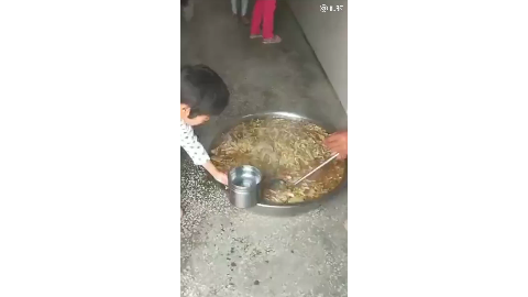 杞县小学生在地上打饭像喂猪 教育局称餐车坏