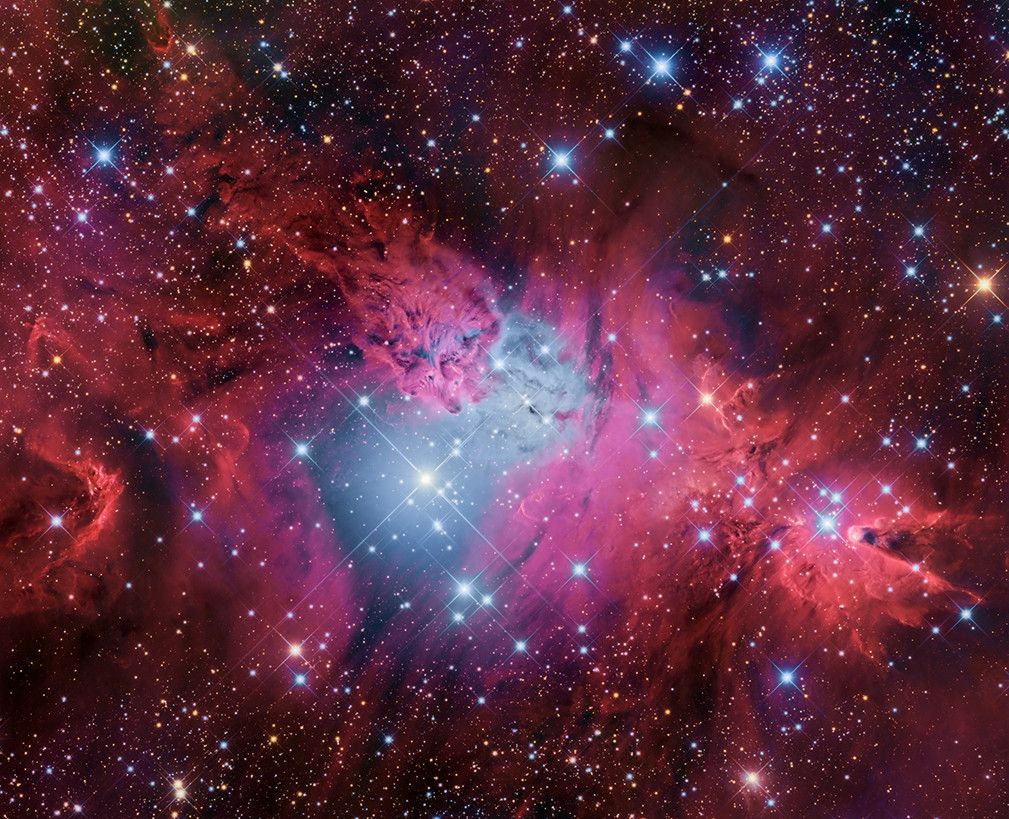 圣诞树发光的氢气云充满了这个五颜六色的天空——一个被称为ngc2264