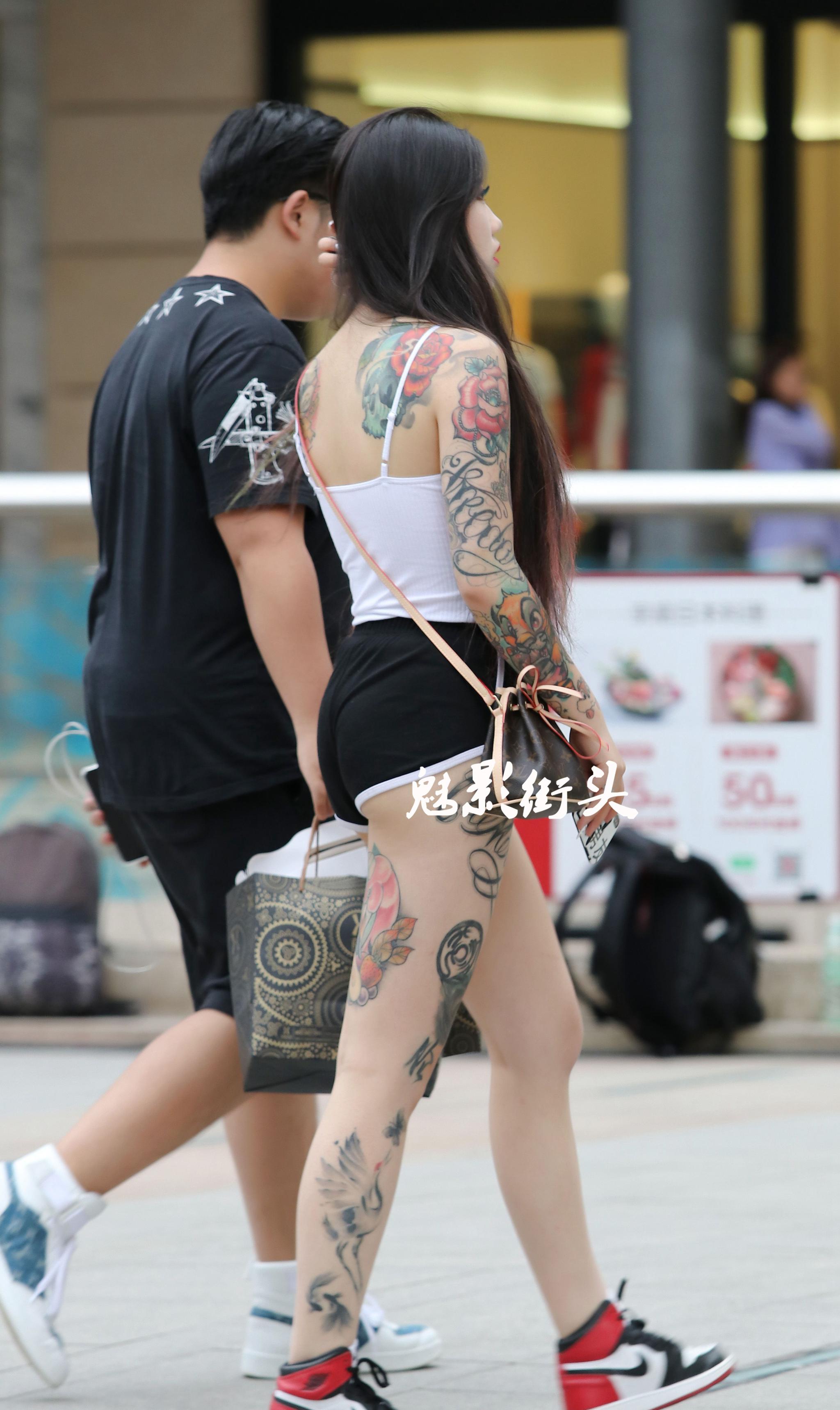 街拍白色吊带t恤搭短裤露出大面积纹身霸气十足很有时尚感
