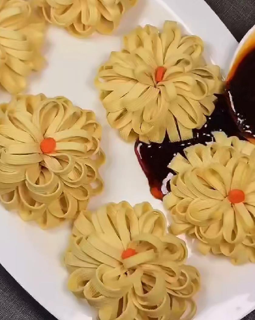 接下来把它从一头卷起;然后再对折切成小窄条,一面别切断;先将干豆腐