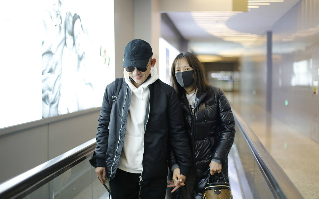 聂远和妻子秦子越手拉手现身机场,夫妻二人造型配一脸