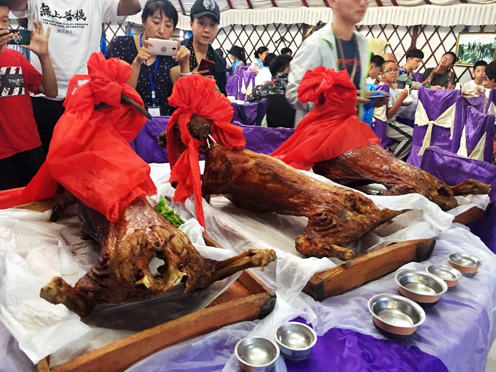 正文              游客们现场拍摄烤全羊