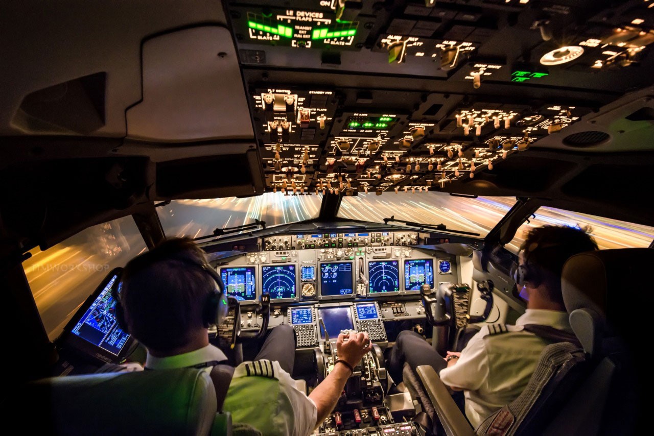 Pilot pushing button in airplane cockpit with co-pilot | Hayat Bilgileri