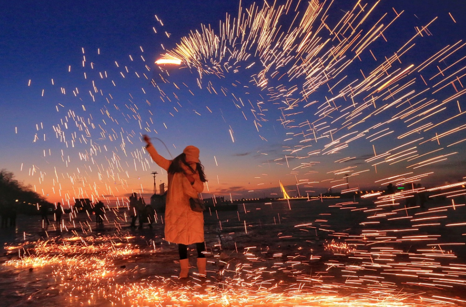 松花江上游客玩手甩烟花,场面壮观