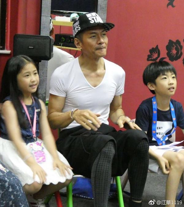 经常运动的他还是有着壮硕的肌肉,戴着帽子的江华还是有着当年的那份