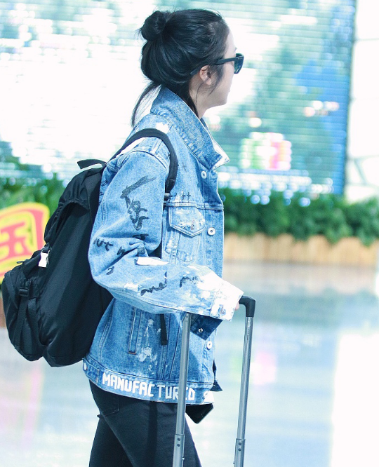 汤唯黑超遮面丸子头轻松随性 自推行李一路语音聊不停