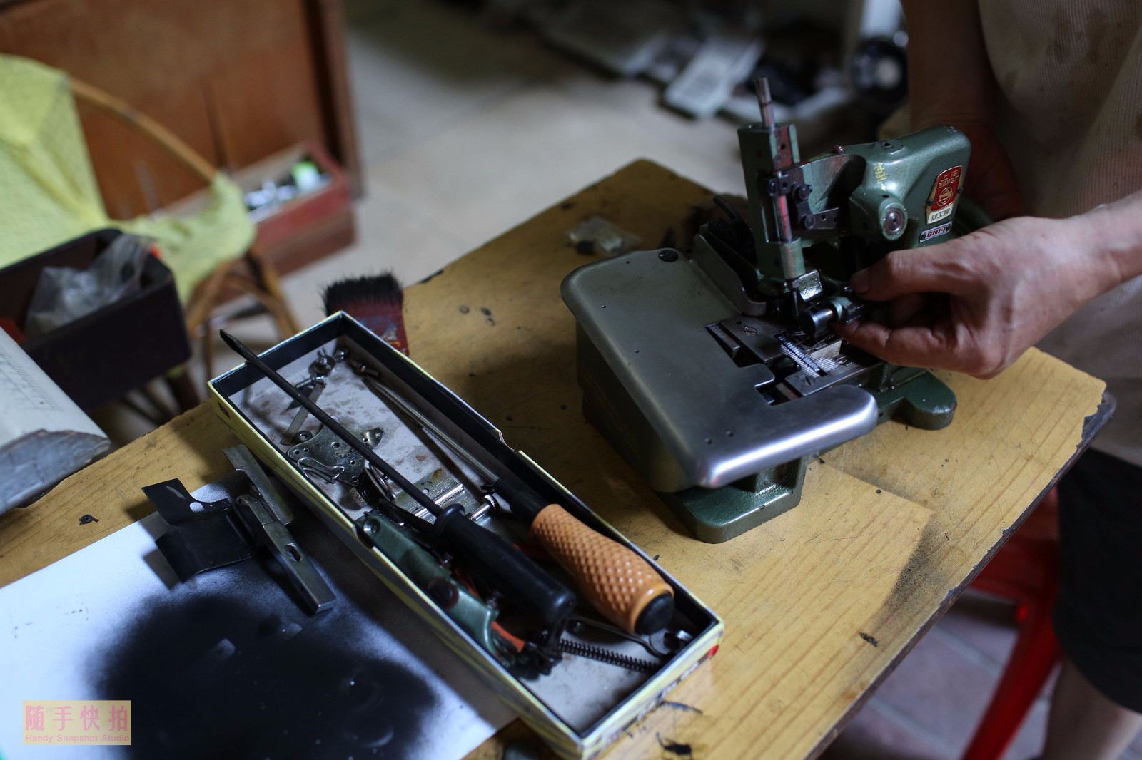 今年近70岁的刘姓(音译)大伯正在认真维修一款上海牌的老式缝纫机