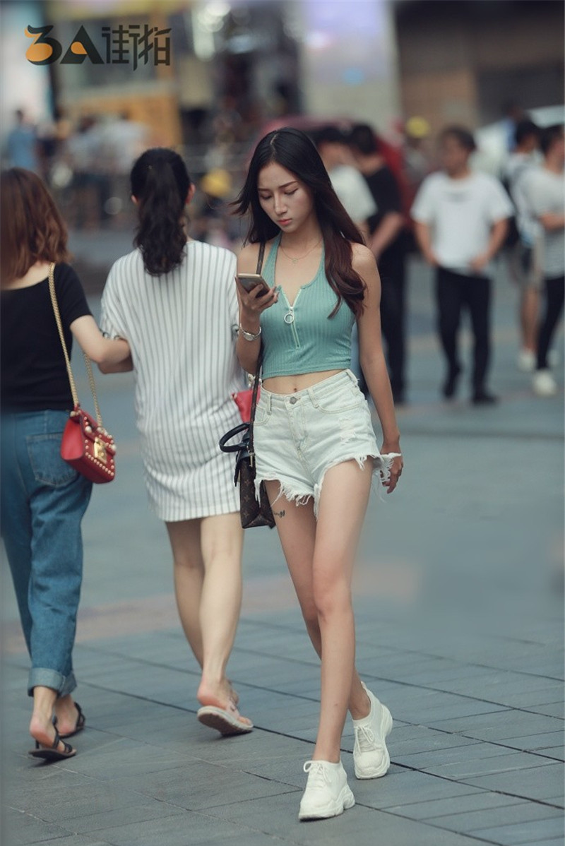 街拍,热裤美女,身穿吊带凉高跟,街上的一道风景