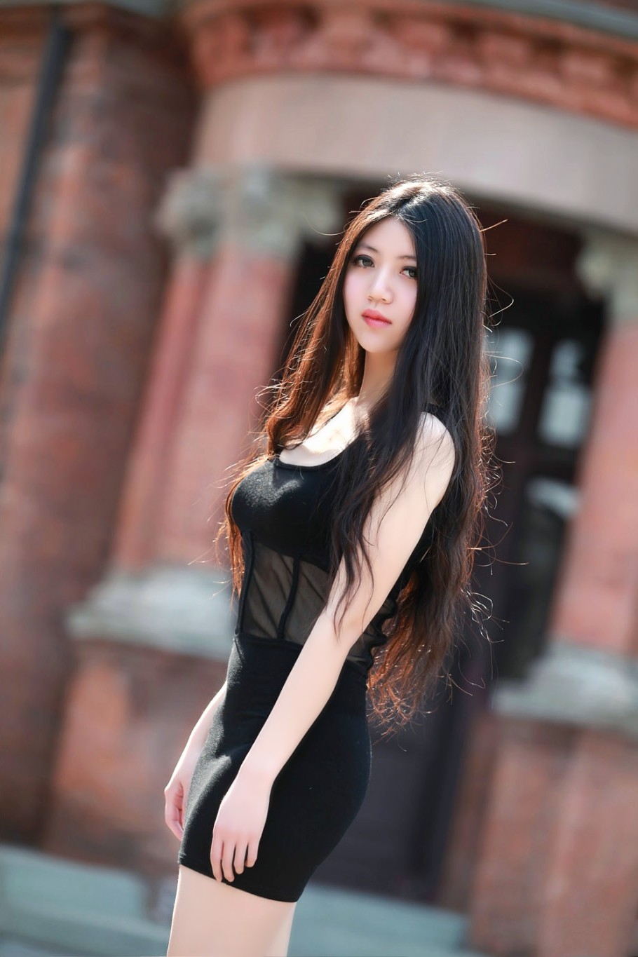 行走在夏日街头的一个长发飘飘清秀女孩