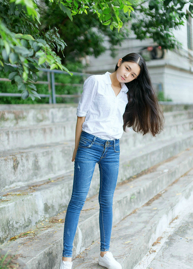 长发美女穿着紧身牛仔裤搭配v领衬衫彰显出邻家女孩的气质