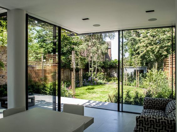 室内与庭院之间,视野开阔的落地窗和一扇通往庭院的小门