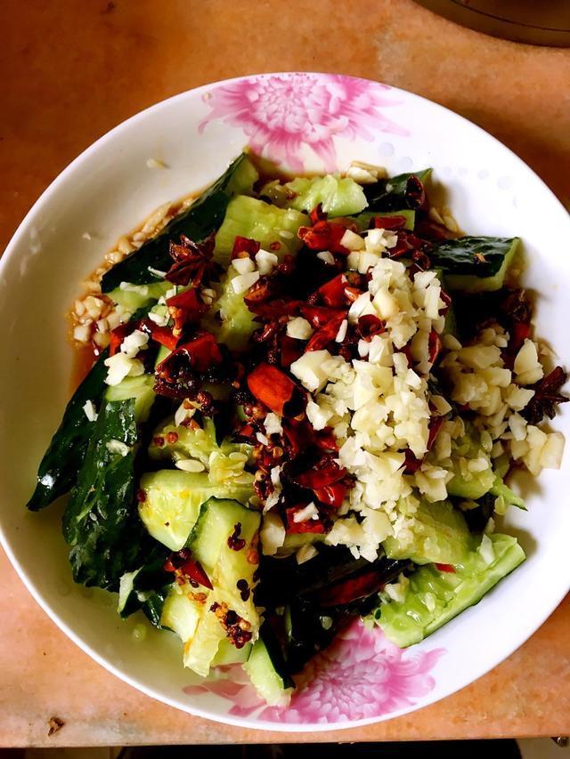 第一步:把黄瓜用刀的平面用力拍扁,然后斜切厚片,加入盆中,倒入适量醋