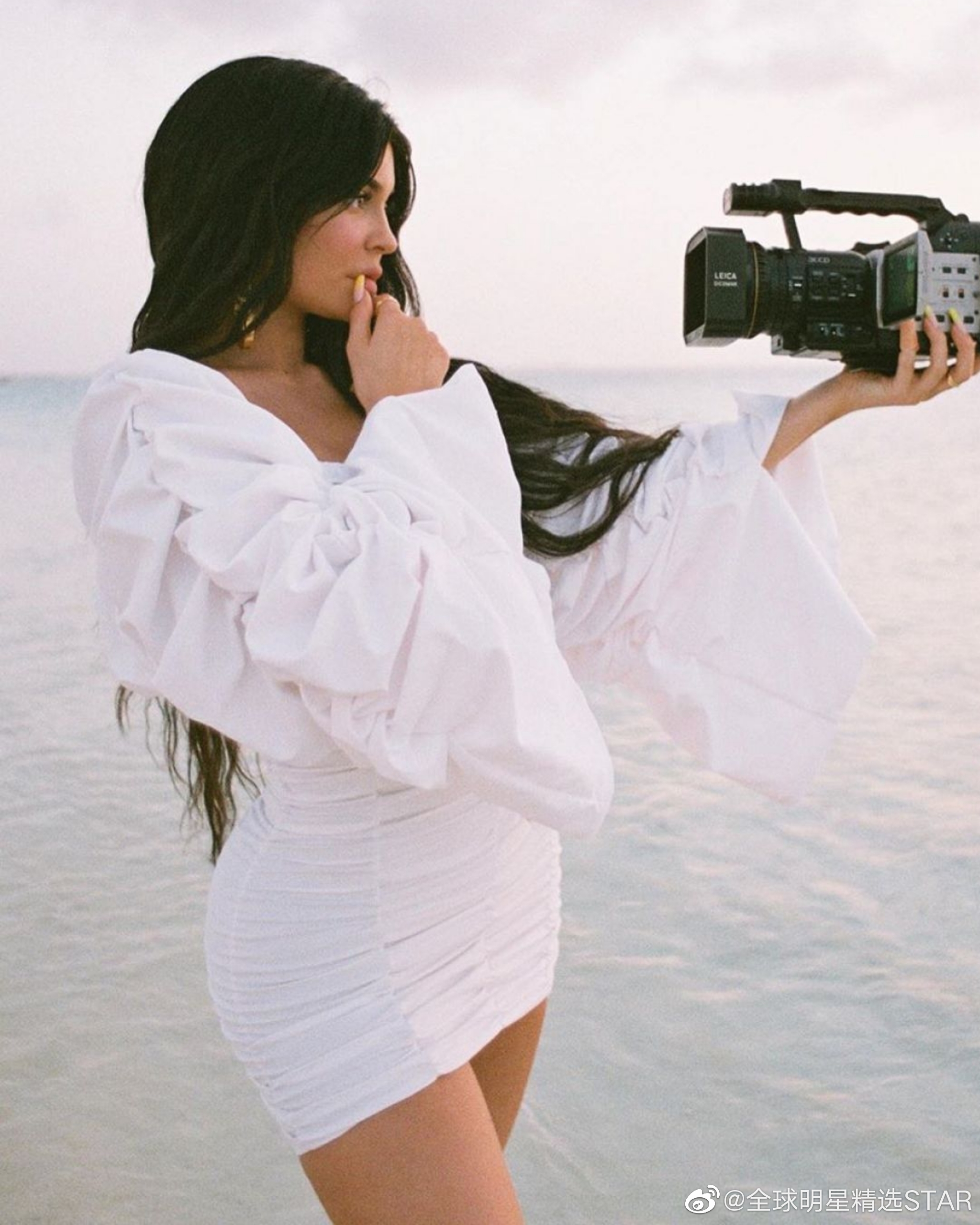 凯莉·詹娜展示海边写真大片,赤脚站在沙滩上,妩媚动人