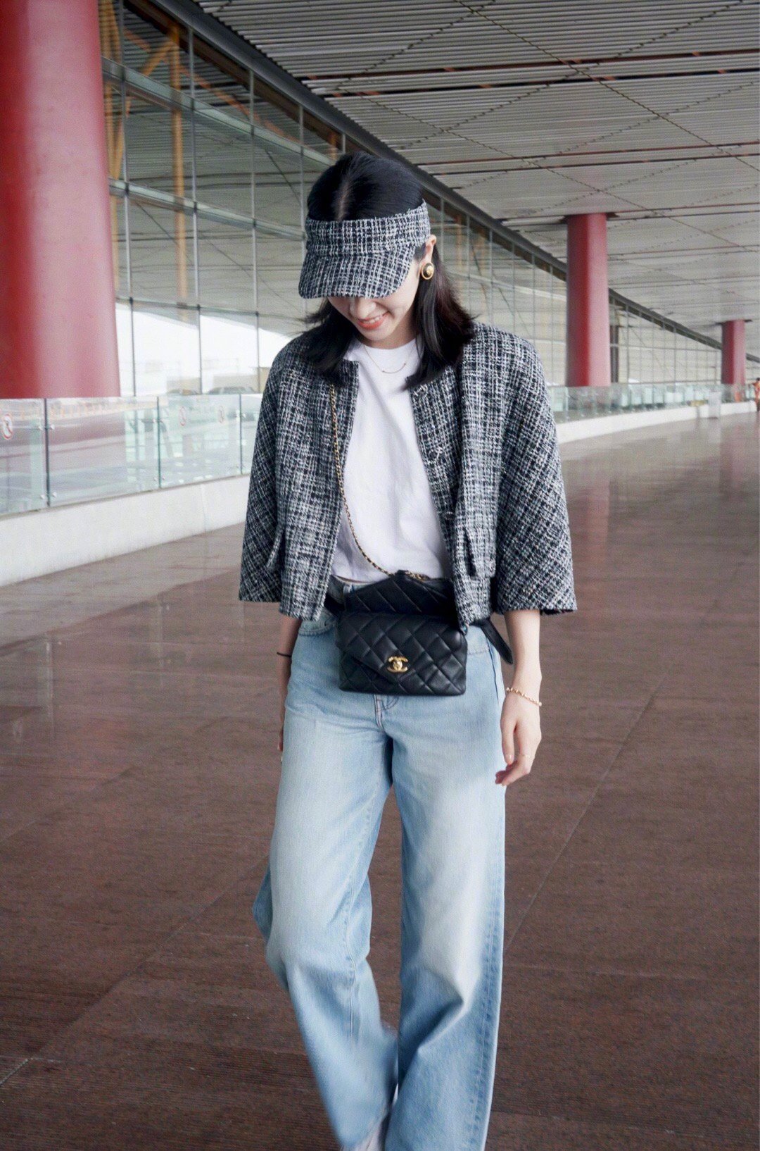 演员的一组机场拍身穿chanel斜纹软呢外套配搭白t恤和牛仔裤