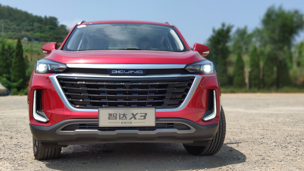 新车标上面是一条银色镀铬饰条,连接两侧的led大灯,横向拉伸了视觉