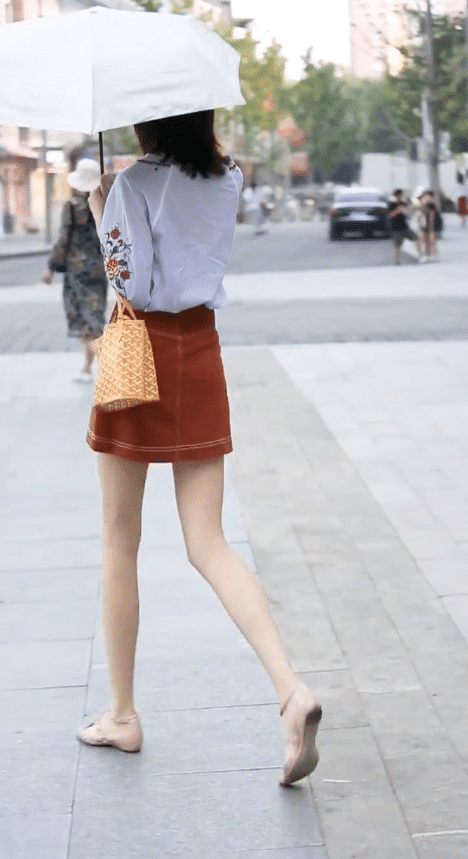 铅笔腿的美女,打伞是怕把白皙的皮肤晒黑?