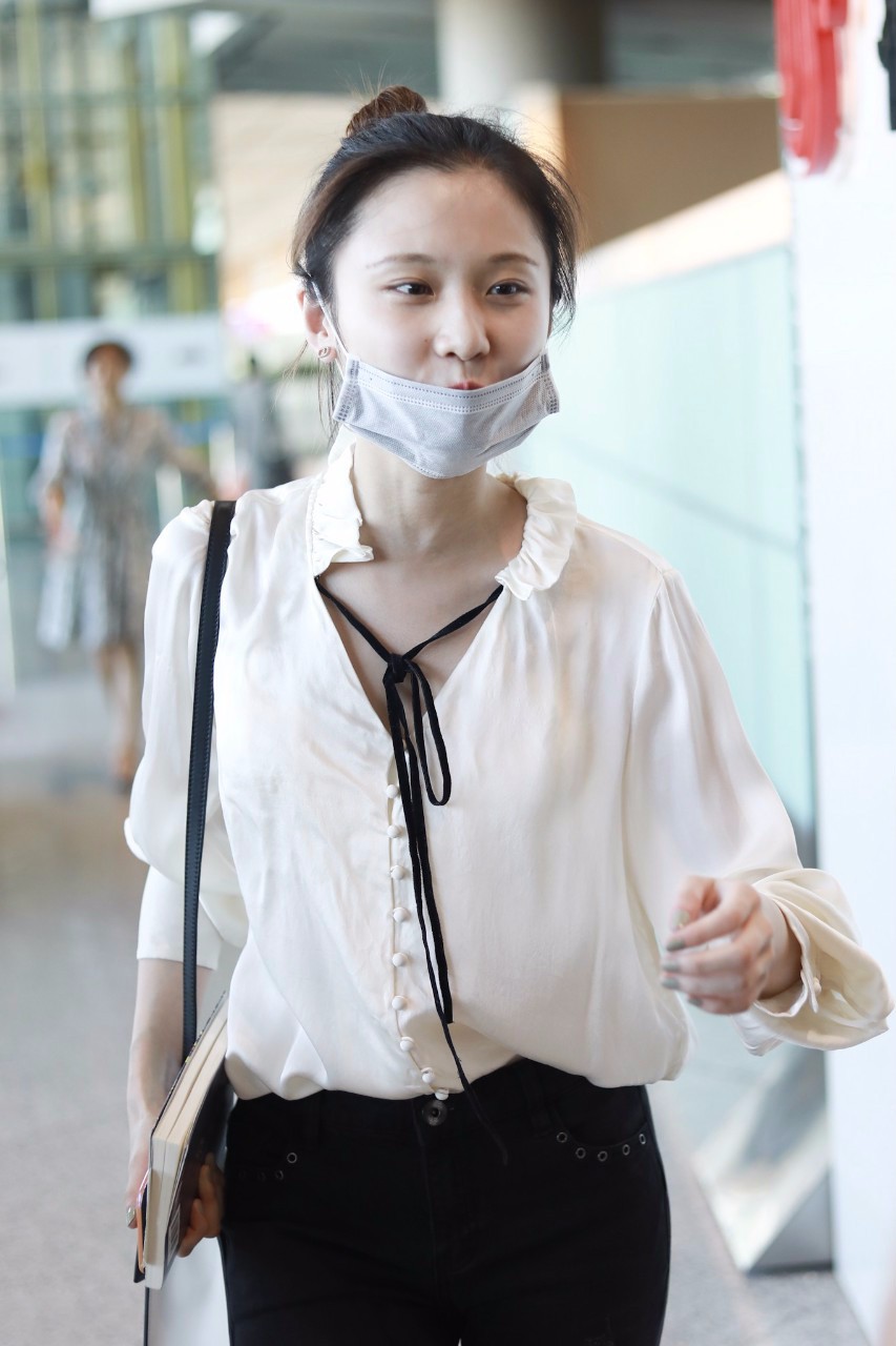 张慧雯穿白色衬衣搭配黑色裤子现身机场皮肤白皙,扎丸子头好可爱