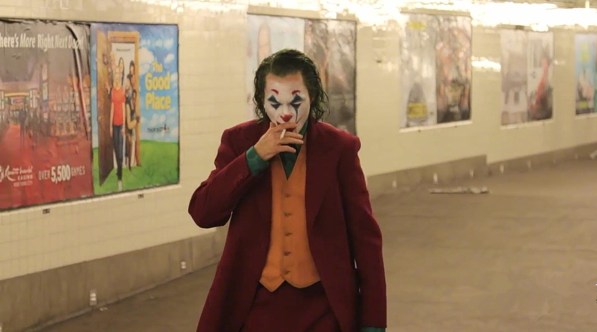 《小丑》杰昆·菲尼克斯叼着烟走出地铁,与一群警察擦肩而过