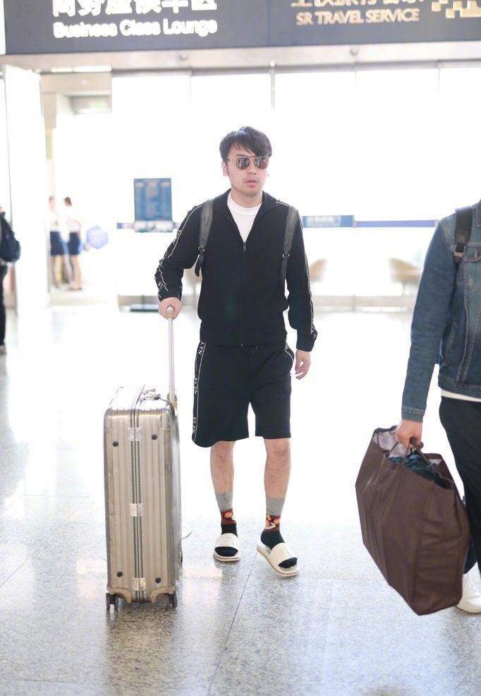 雷佳音最新机场照, 拖鞋配袜子表情迷茫, 身后妹子掩面而笑!