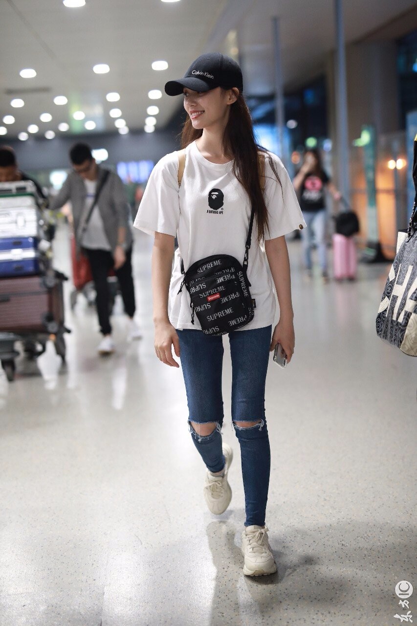 林允穿白t搭配蓝色破洞牛仔裤现身机场笑容甜美比剪刀手卖萌