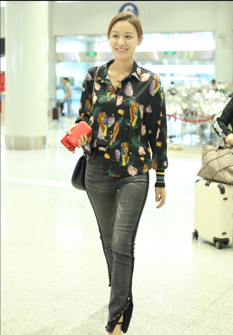 叶一茜穿花衬衫搭配黑色牛仔裤现身机场依旧光彩耀人气质好