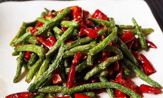 洗干净并控干水分备用,然后起锅烧油,把控干水分的四季豆放在锅里面炸