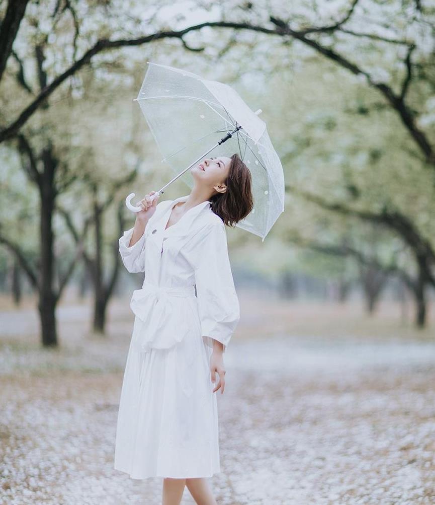 張蕾雨中漫步太迷人,穿白色連衣裙配小白鞋,撐傘一笑高級又養眼