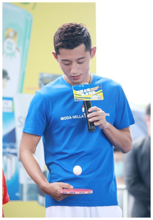 从照片可以看到,穿着一件蓝色t恤亮相的张继科,一手拿着话筒,一手拿着