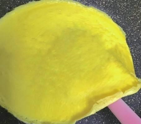 5,把煎好的蛋皮放在案板上,然后把芋头泥均匀的涂在蛋皮上,然后在拿蛋