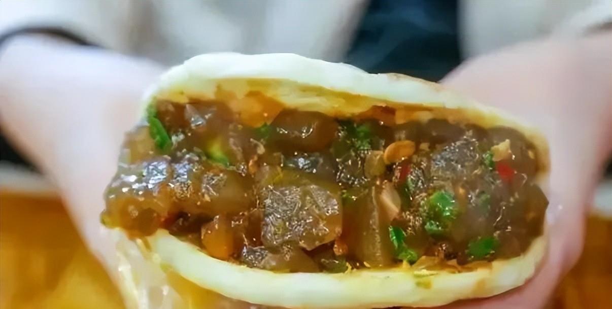 平底锅里放辣豆酱,将凉粉煎炒至起金黄痂,佐以青红鲜辣椒碎丁,撒葱花