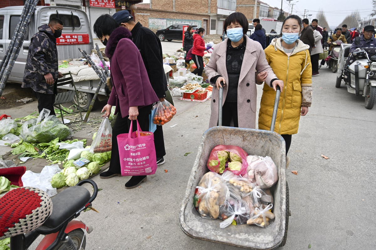 春节集市人声鼎沸热闹依旧,乡情浓郁处,唯有一个镜头与往年不同