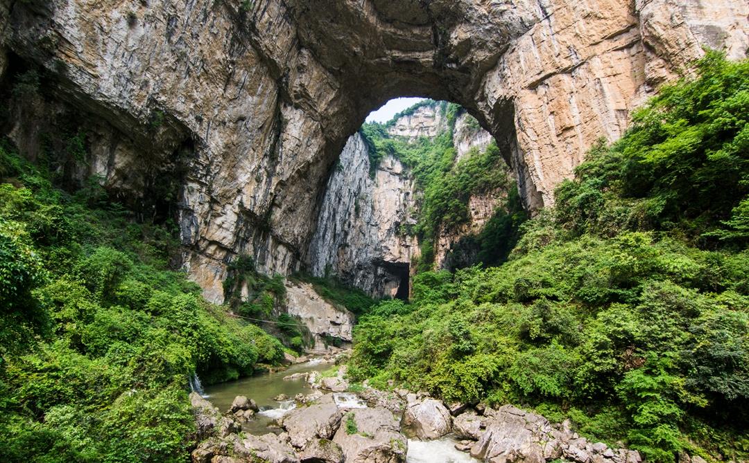 贵州有个神奇天坑,瀑布从洞穴轰隆流出,成群燕子一直在天窗盘旋