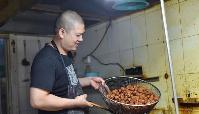 向荣街一家卖焦丸子的小店里,今年37岁的店主王华飞正在油锅里捞丸子