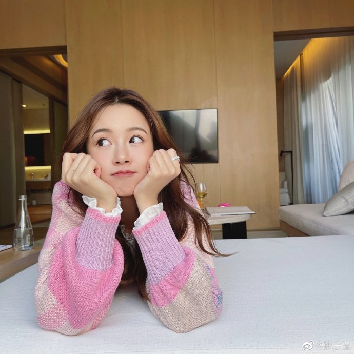 张子萱穿粉色毛衣长卷发温柔 双手比耶做搞怪表情可爱
