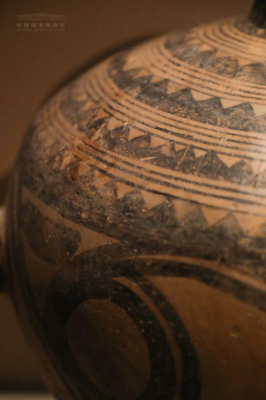 马家窑类型锯齿纹为单一的黑彩,锯齿大而疏朗,呈大三角状