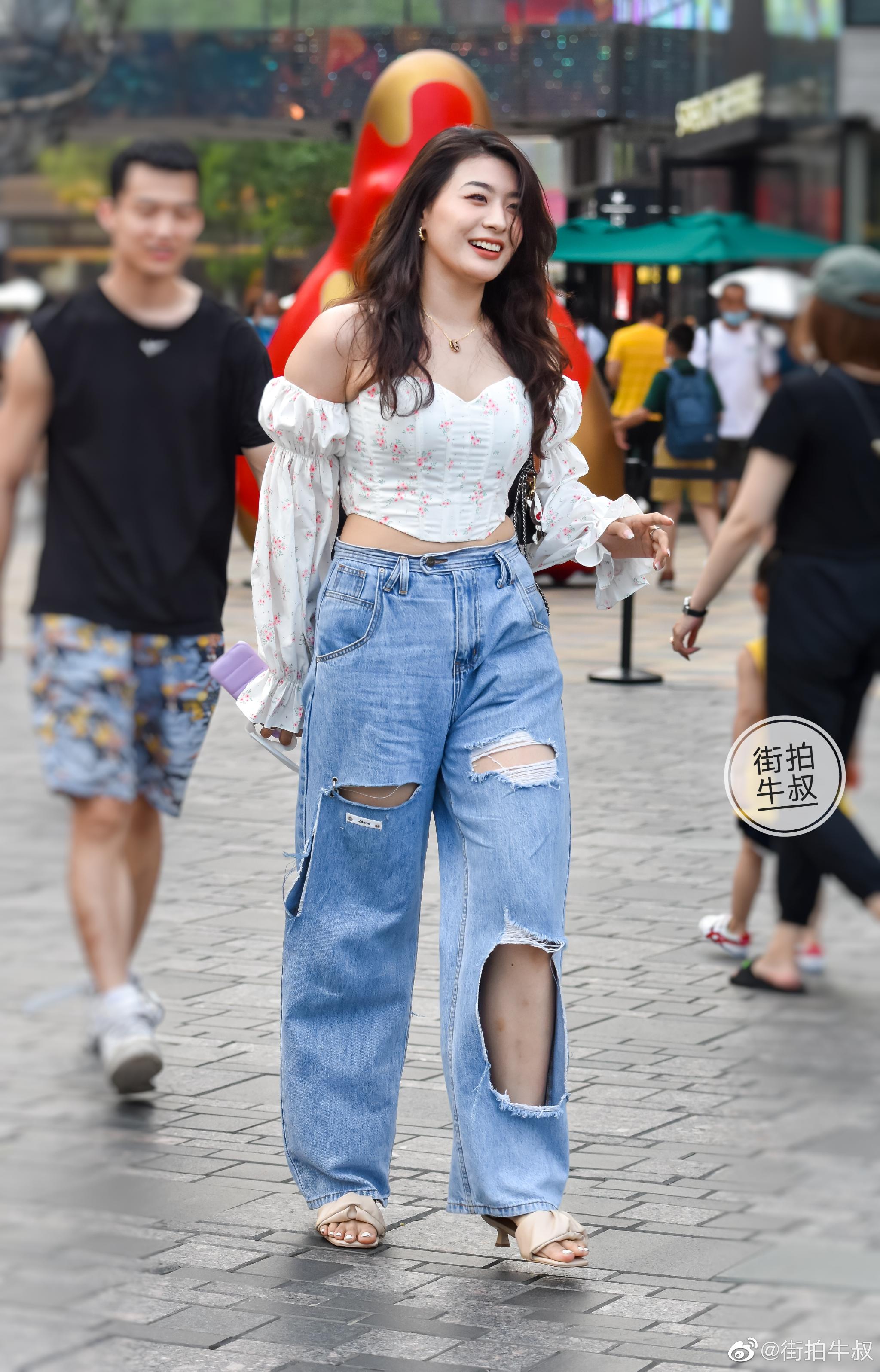 美女穿着一字肩泡泡袖碎花衬衫出街